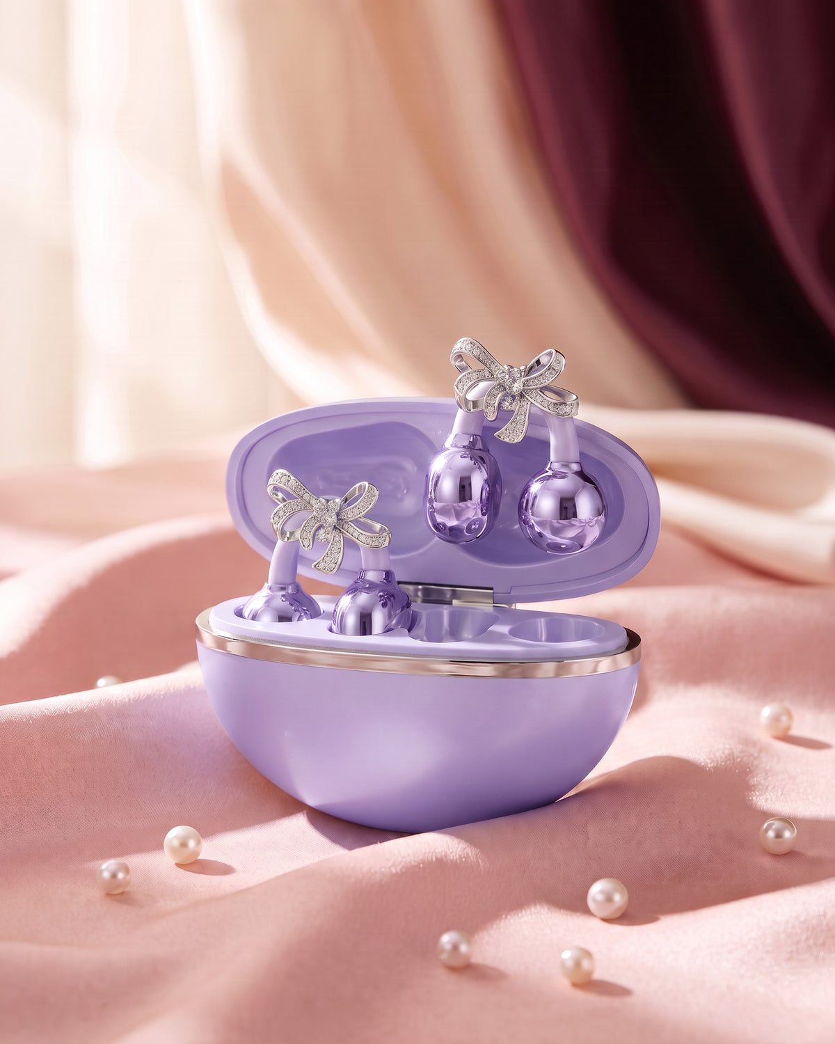 Nacary clip-on earbuds in Lilac with crystal bow charms in the open charging case