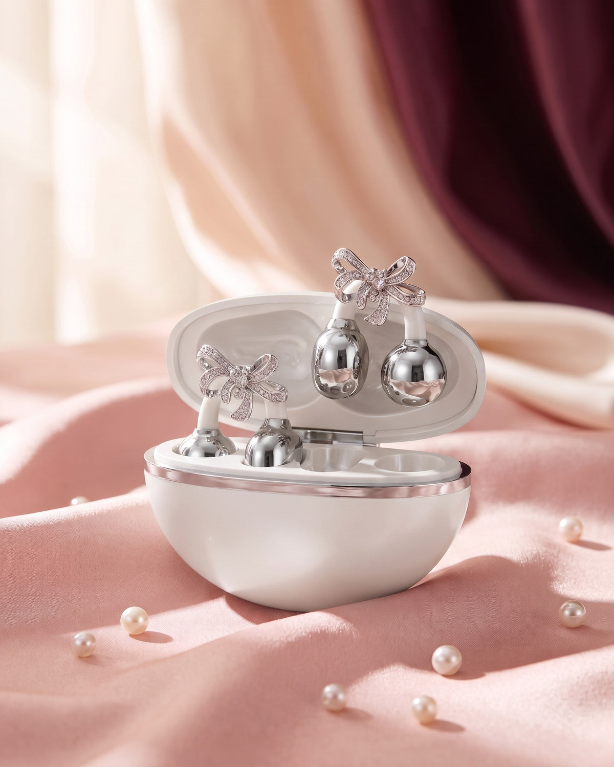 Nacary clip-on earbuds in Pearl with crystal bow charms in the open charging case