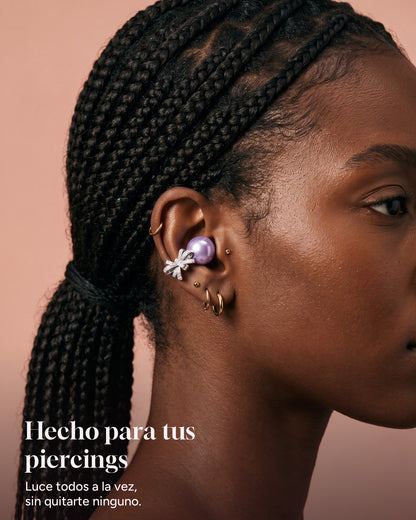Nacary earbud in Lilac worn alongside several ear piercings